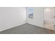 Bedroom with a window and a bathroom entrance featuring tile flooring at 16450 Bird Of Paradise Ave, Clermont, FL 34714