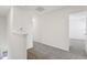 Second-floor hallway with gray carpet and white walls at 16450 Bird Of Paradise Ave, Clermont, FL 34714