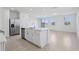 Modern kitchen with stainless steel appliances, an island with a sink, and backyard views at 16450 Bird Of Paradise Ave, Clermont, FL 34714