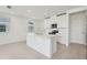 Bright, modern kitchen with white cabinets, stainless steel appliances, a kitchen island, and an open-concept layout at 16450 Bird Of Paradise Ave, Clermont, FL 34714