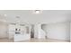 Open-plan kitchen features white cabinetry, stainless steel appliances, island with seating, and plenty of natural light at 16450 Bird Of Paradise Ave, Clermont, FL 34714