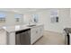 Bright kitchen features an island with a sink, stainless steel appliances, and backyard views at 16450 Bird Of Paradise Ave, Clermont, FL 34714
