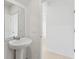 Cozy powder room featuring pedestal sink, neutral paint and tile flooring at 16450 Bird Of Paradise Ave, Clermont, FL 34714