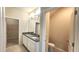 Well-lit bathroom with a double vanity, granite countertops, and a separate toilet room at 16749 Harper Cove Dr, Winter Garden, FL 34787