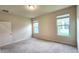 Cozy bedroom with two windows and a door, and neutral carpet for a relaxing ambiance at 16749 Harper Cove Dr, Winter Garden, FL 34787