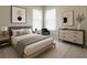 Stylish bedroom featuring a sleek bed, modern art, and coordinated decor for a contemporary and inviting space at 16749 Harper Cove Dr, Winter Garden, FL 34787