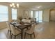 Bright dining area featuring an elegant table set for six, seamlessly connected to the comfortable living space at 16749 Harper Cove Dr, Winter Garden, FL 34787