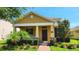 Charming home featuring a cozy front porch, well-manicured lawn, and vibrant landscaping at 16749 Harper Cove Dr, Winter Garden, FL 34787
