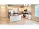 Bright open kitchen featuring an island, granite counters, stainless appliances, and ample cabinet space at 16749 Harper Cove Dr, Winter Garden, FL 34787