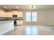 Open-concept living area with bright natural light, tile floors, and a modern chandelier at 16749 Harper Cove Dr, Winter Garden, FL 34787