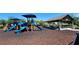 Community playground with colorful slides and picnic shelter provides an engaging recreational space for families to enjoy at 16749 Harper Cove Dr, Winter Garden, FL 34787