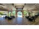 Inviting pool-side lounge area with comfortable seating, framed by tropical palm trees and sunny skies at 16749 Harper Cove Dr, Winter Garden, FL 34787