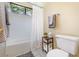 Bright bathroom featuring a shower-tub combo, neutral walls, and tile floors at 1709 Winter Green Blvd, Winter Park, FL 32792