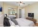 Bright bedroom featuring large mirrored closet doors, ceiling fan, and TV console at 1709 Winter Green Blvd, Winter Park, FL 32792