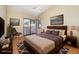 Comfortable bedroom featuring a sliding door, wood accents, ceiling fan and neutral decor at 1709 Winter Green Blvd, Winter Park, FL 32792