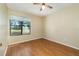 Standard bedroom has a window, hardwood floor and ceiling fan at 1709 Winter Green Blvd, Winter Park, FL 32792