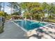 Sparkling community pool with a covered patio and lounge chairs, perfect for relaxation at 1709 Winter Green Blvd, Winter Park, FL 32792