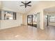 A bright and spacious living room with sliding glass doors to the outdoor area and tile flooring throughout at 1709 Winter Green Blvd, Winter Park, FL 32792