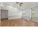 Bright living room featuring vaulted ceilings, neutral gray walls, a ceiling fan, wood-look flooring and a window at 1811 Oakgrove Ave, Deltona, FL 32725