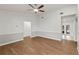 Inviting living room with beautiful wood flooring, neutral gray walls, a ceiling fan, and natural light at 1811 Oakgrove Ave, Deltona, FL 32725