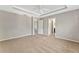 Spacious bedroom with a tray ceiling and neutral carpeting at 2005 E Grant Ave, Orlando, FL 32806