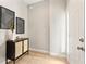 Inviting entryway features a stylish cabinet, artistic wall decor, and tile flooring at 2005 E Grant Ave, Orlando, FL 32806
