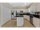 Spacious kitchen with white cabinetry, black countertops, and stainless steel appliances at 2005 E Grant Ave, Orlando, FL 32806