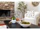 Close up of a decorated coffee table in front of stone fireplace with modern decor at 2005 E Grant Ave, Orlando, FL 32806