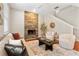 Cozy living room featuring a stone fireplace, plush seating, and staircase at 2005 E Grant Ave, Orlando, FL 32806