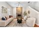 Comfortable living room with stone fireplace, plush seating, and natural light at 2005 E Grant Ave, Orlando, FL 32806