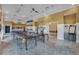 Brightly lit activity room with tables, chairs, and neutral walls providing an open and creative space at 228 Bayou Bend Rd, Groveland, FL 34736