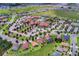 An aerial view shows the community center with pool, tennis courts, and surrounding houses at 228 Bayou Bend Rd, Groveland, FL 34736