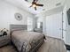 Bedroom featuring laminate floors, ceiling fan, closet, dresser, and decor at 228 Bayou Bend Rd, Groveland, FL 34736