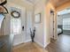 Bright foyer with tile flooring, a decorative front door, and views leading to the living spaces and a bedroom at 228 Bayou Bend Rd, Groveland, FL 34736