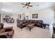 Bright and airy living room connects seamlessly to the dining area with comfortable furniture at 228 Bayou Bend Rd, Groveland, FL 34736