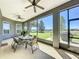 The screened-in patio has a table and chairs, offering backyard views at 228 Bayou Bend Rd, Groveland, FL 34736