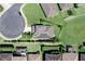 Aerial view of home with solar panels, green lawn, and screen-enclosed patio at 2319 Grantham Ave, Davenport, FL 33837