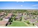 Aerial view of the backyard with a lawn, bordered by lush greenery and privacy fencing at 2319 Grantham Ave, Davenport, FL 33837