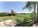 Fenced backyard with a stone tiled patio area and lush green lawn with views of surrounding properties at 2319 Grantham Ave, Davenport, FL 33837