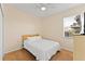 Bedroom with a simple wood-framed bed, and a bright window at 2319 Grantham Ave, Davenport, FL 33837