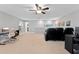 Large bonus room featuring a ceiling fan, computer and home theater setup, and a doorway to a bathroom at 2319 Grantham Ave, Davenport, FL 33837