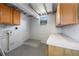 Functional basement laundry room with storage cabinets and window view at 2429 Yale Ave, Sanford, FL 32771