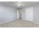 Well-lit bedroom featuring tile floors, a ceiling fan, and two entry doors at 2429 Yale Ave, Sanford, FL 32771