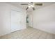 Clean bedroom features tile floor, ceiling fan and doors to the hallway and closet at 2429 Yale Ave, Sanford, FL 32771