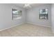 Bright bedroom with two windows for natural light and neutral tile flooring at 2429 Yale Ave, Sanford, FL 32771