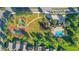 Aerial view of community amenities featuring tennis courts, a playground, and a sparkling swimming pool at 2867 Oconnell Dr, Kissimmee, FL 34741