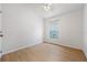 Light-filled bedroom with wood laminate flooring, fan and window to the outside at 2867 Oconnell Dr, Kissimmee, FL 34741