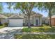 Attractive one-story house with well-maintained lawn and two-car garage at 2867 Oconnell Dr, Kissimmee, FL 34741