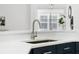 Close-up of a kitchen sink featuring a sleek faucet and bright countertop with a window providing natural light at 2867 Oconnell Dr, Kissimmee, FL 34741