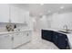 Well-lit kitchen with white cabinetry, stainless steel appliances, and ample counter space at 2867 Oconnell Dr, Kissimmee, FL 34741